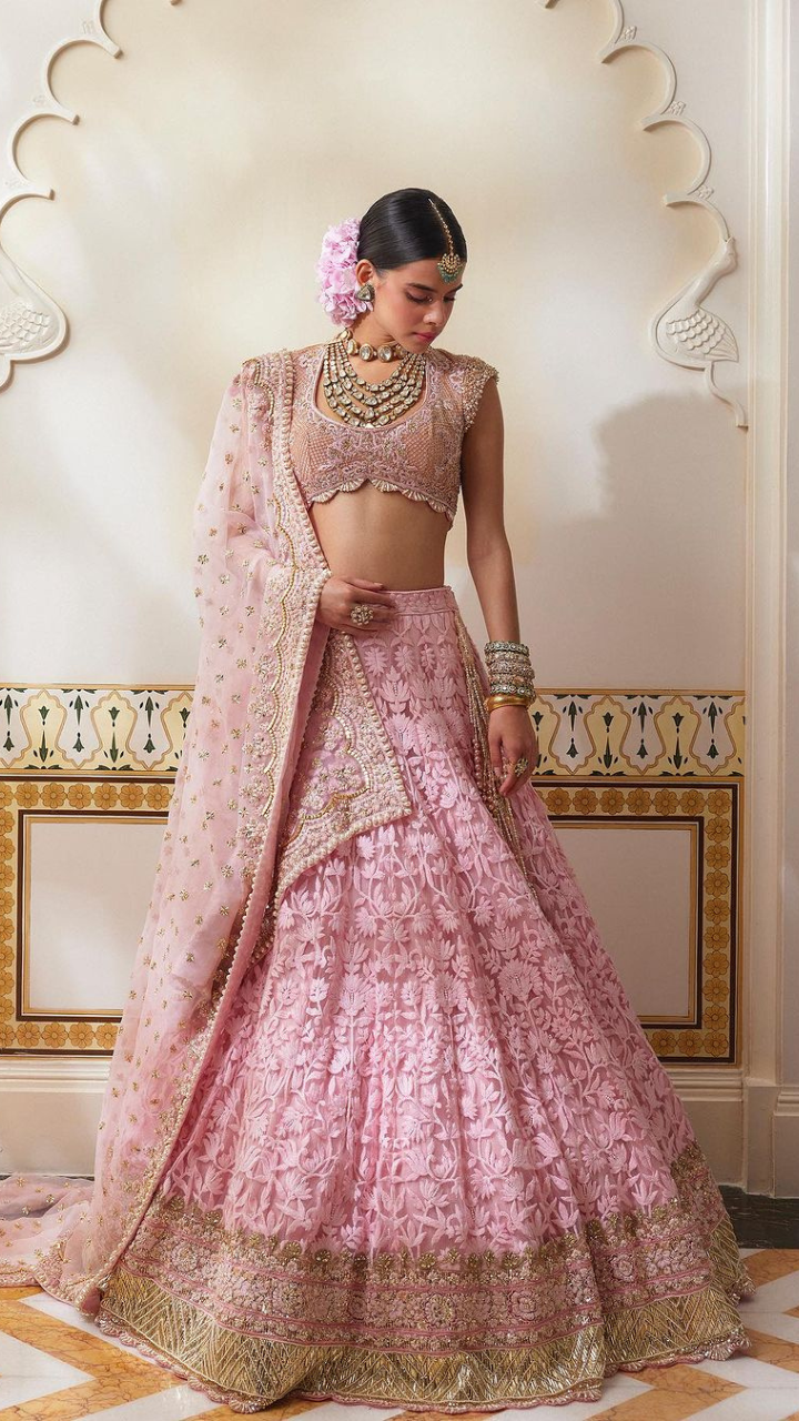 Indian Bride In Baby Pink Gold And Silver Bridal Lehenga With Gold Bridal  Jewellery | Bridal lehenga, Indian wedding outfits, Indian bride