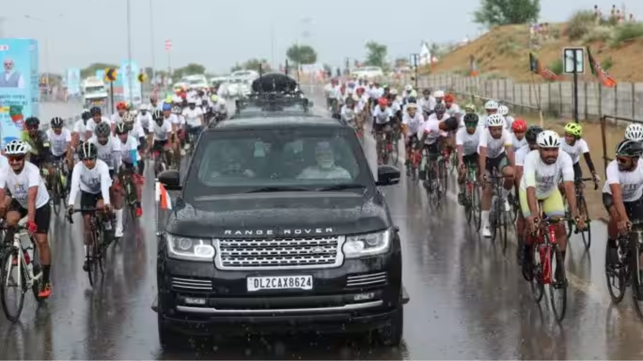 Rain Cyclists And Convoy