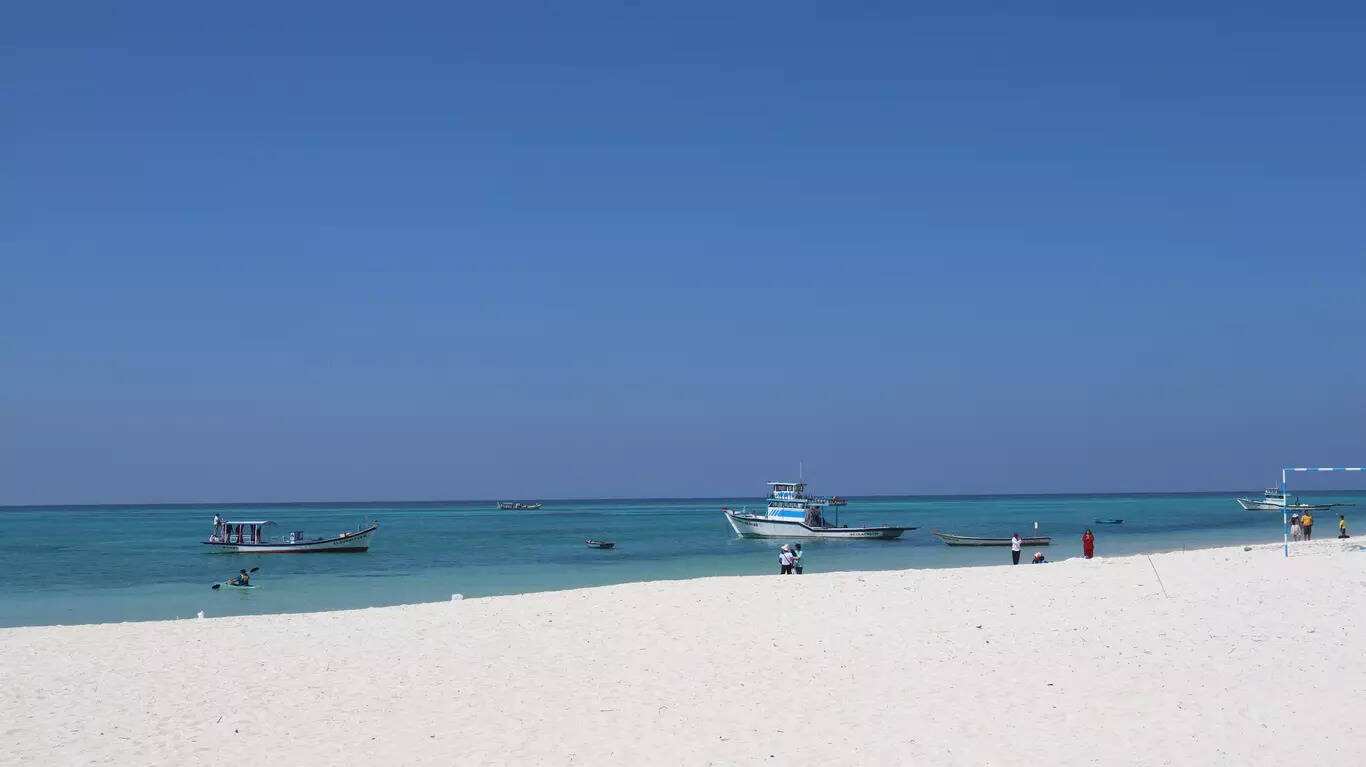 Boats sailing under blue skies in Lakshadweep (Photo Credit: iStock)