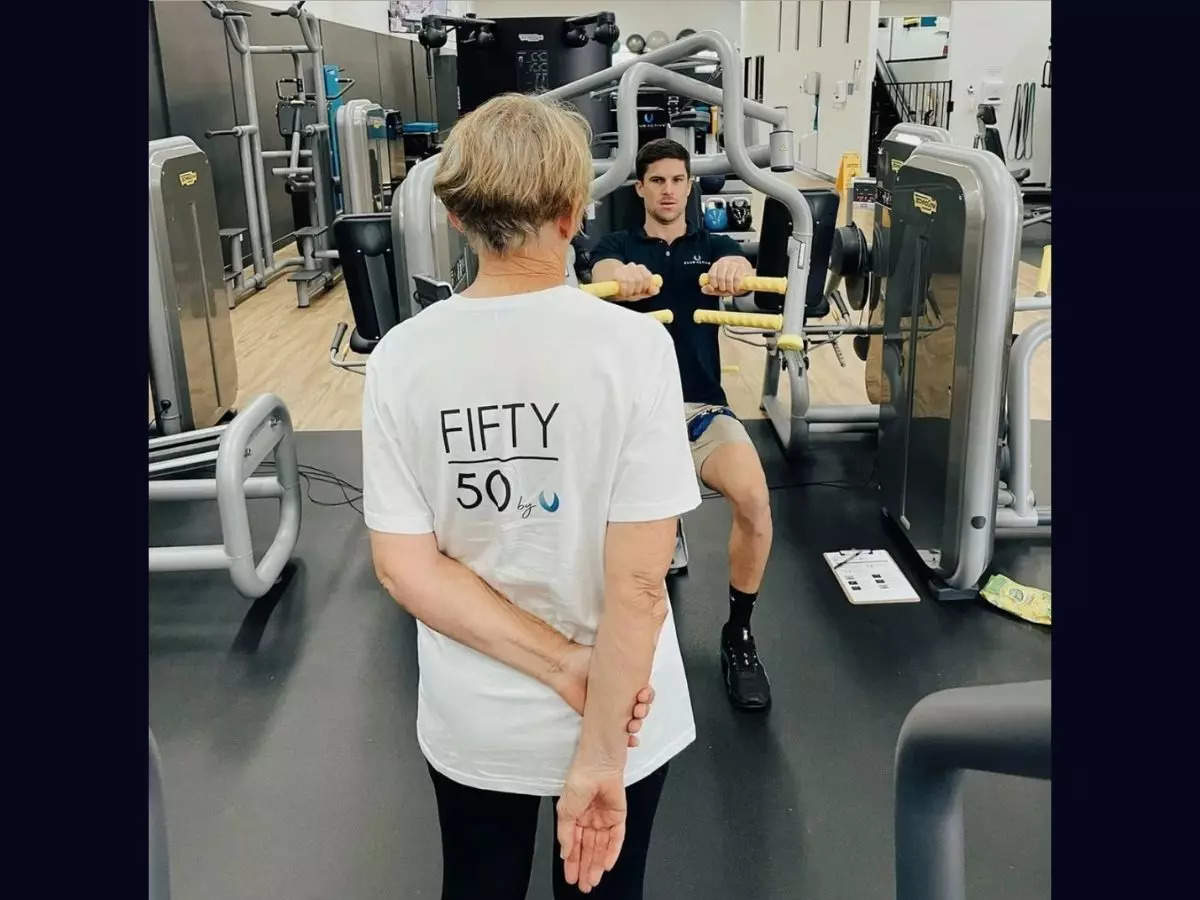 A senior wearing gym merchandise faces a younger man | Image courtesy: Club Active