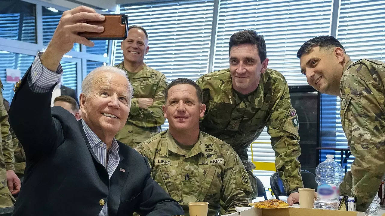 ​US President Joe Biden takes a photo with members of the 82nd Airborne Division on the ground in Poland