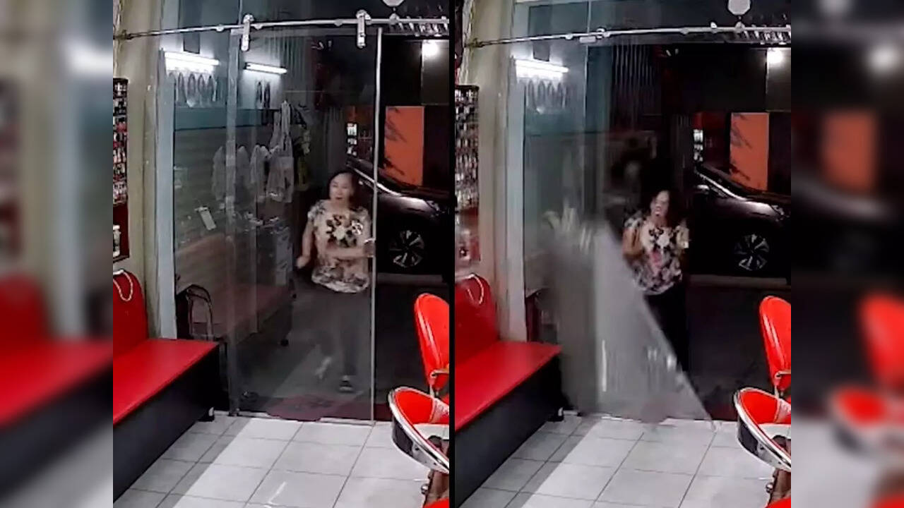 Viral video Oblivious woman runs straight into glass door, knocks it over