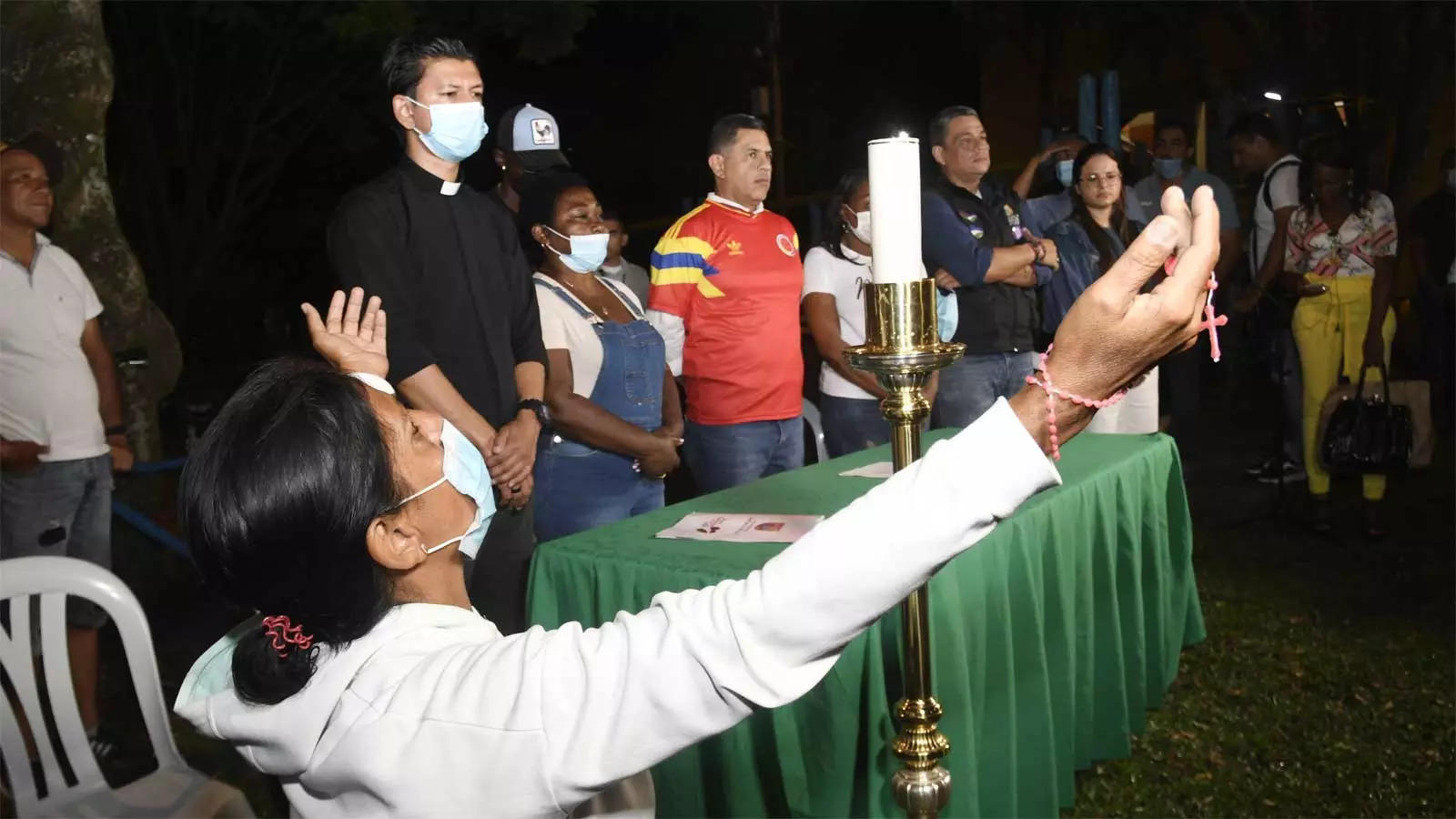 Relatives and friends of former Colombia soccer midfielder Freddy Rincon, who was seriously injured in a traffic accident, pray for him during candlelight vigil near the hospital