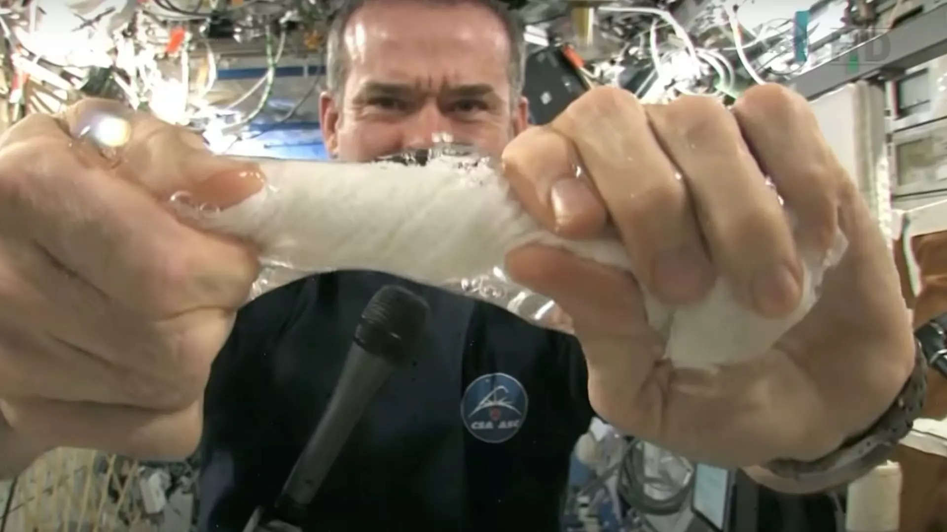 Chris Hadfield wringing out a washcloth on ISS | Canadian Space Agency