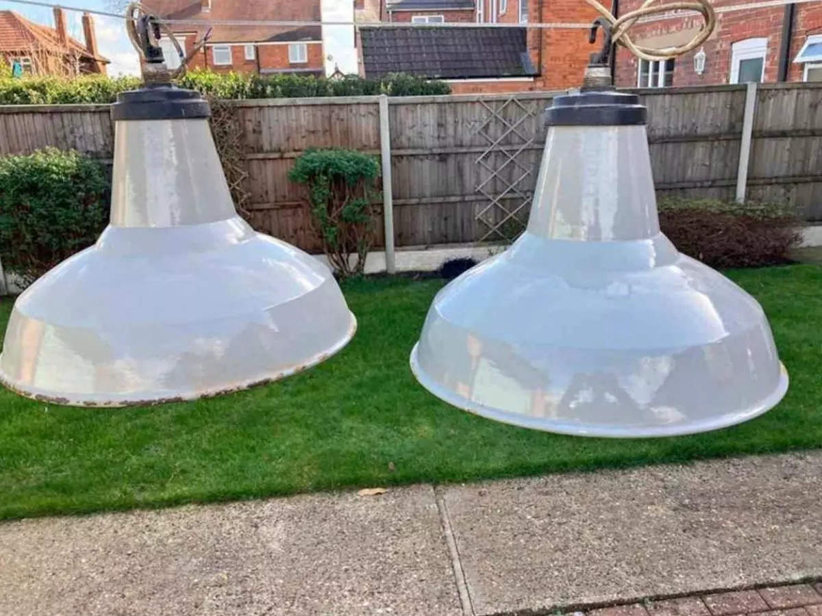 Optical illusion depicting oversized lamps in a yard