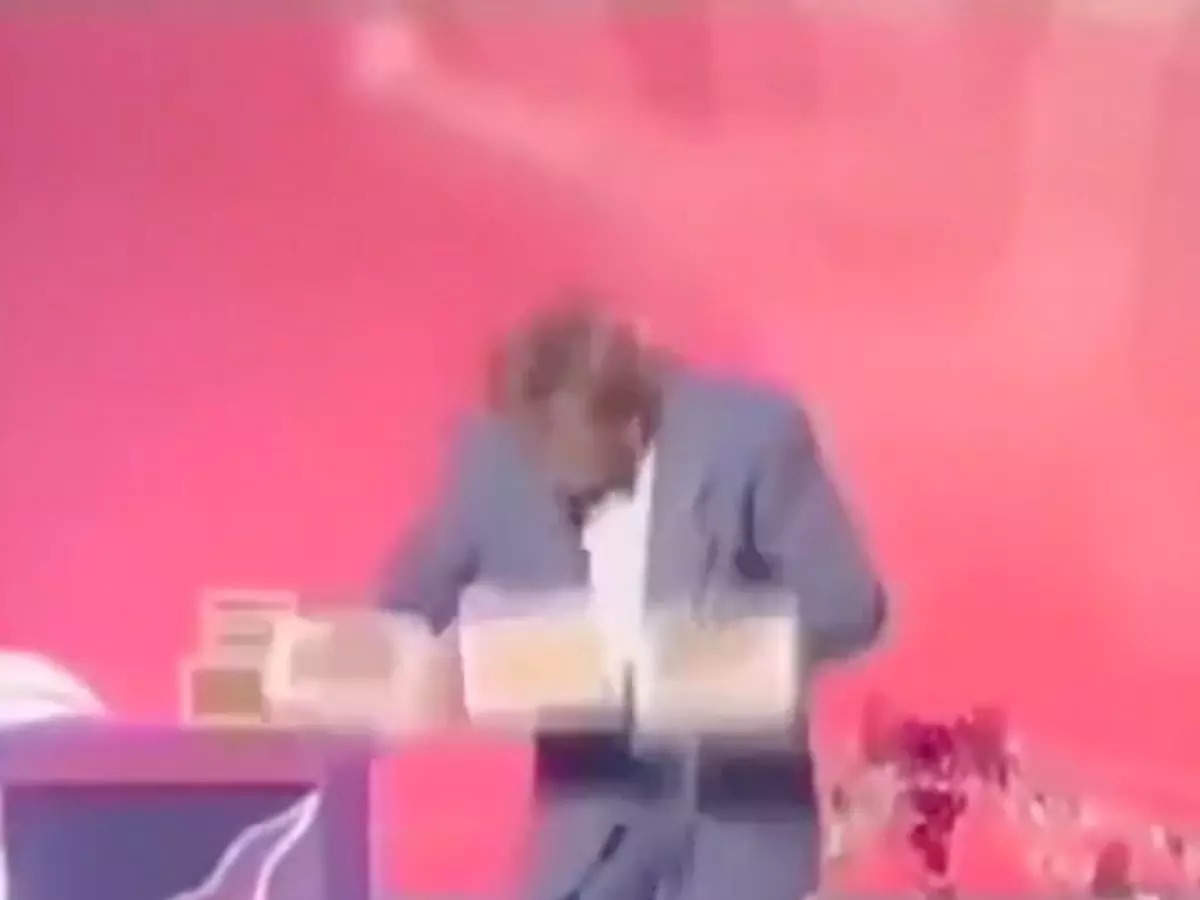 Magician juggles three boxes with two hands