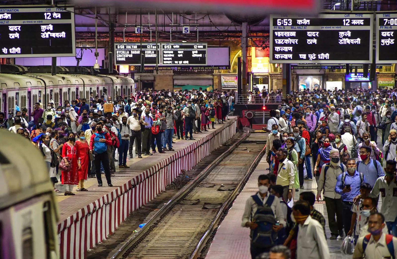 Mumbai: Commuters wait for their trains at platforms at the CSMT Station, in Mum...