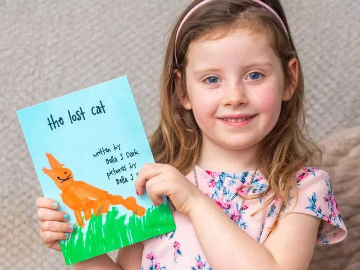 Five-year-old Bella Jay Dark pictured with her book 'The Lost Cat | Picture credit: The Sun/SWNS