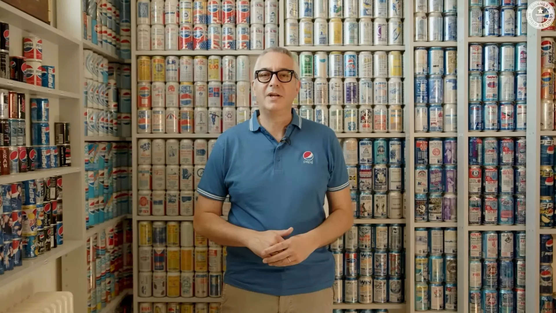 Christian Cavaletti​, pictured with the world's largest collection of Pepsi cans | Image courtesy: Guinness World Records/Youtube