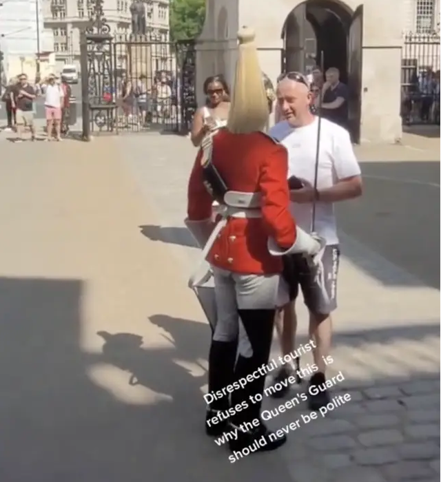 Tourist refuses to move out of Queen Guards way interrupts his march