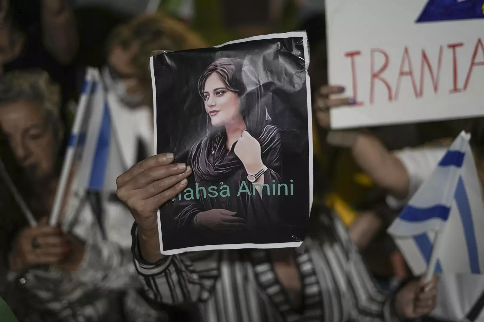 Women take part in a protest against Masa Amini's death during a rally in Tel Aviv.