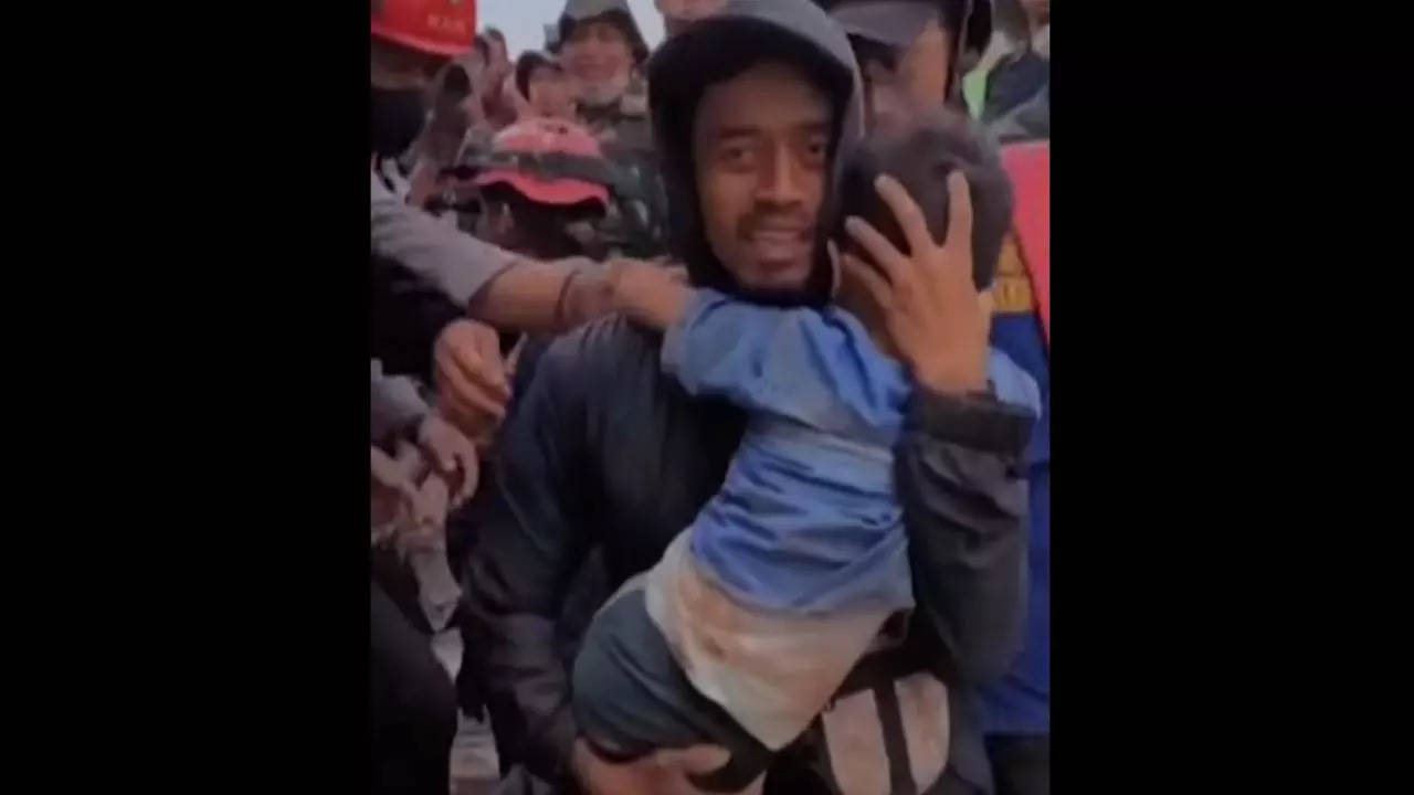 Screengrab from footage released by Bogor Administration shows a six-year-old being rescued from the rubble of his house that collapsed after Monday's earthquake in Indonesia