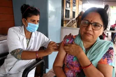 Bhopal: A health worker administers a precaution dose of Covid-19 vaccine to a woman under 'COVID Vaccination Amrit Mahotsava', in Bhopal on Friday, July 15, 2022. The programme was launched by Union Minister Mansukh Mandaviya, in which adults can get a free dose for the next 75 days. (PHOTO: IANS/Hukum Verma)