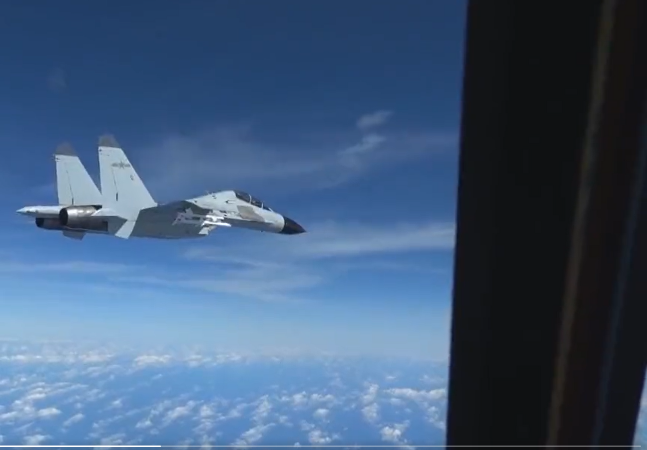 A Chinese J-11 fighter jet flies within 20 feet from US Air Force aircraft