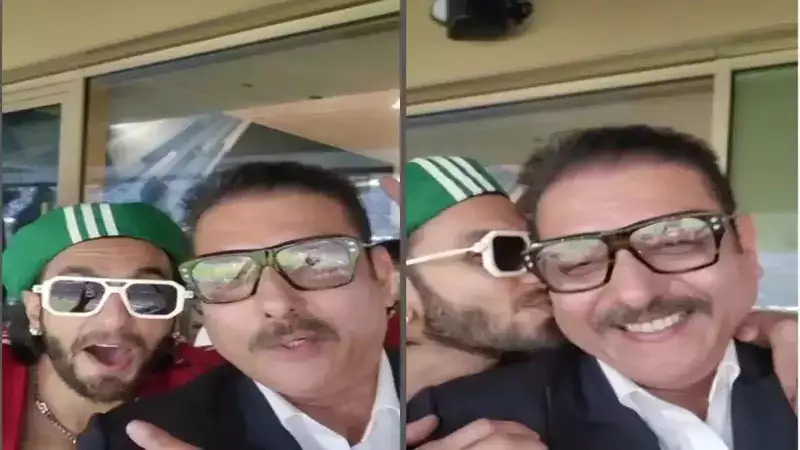 Ranveer Singh plants a kiss on Ravi Shastri’s cheek as they attend the FIFA World Cup finals