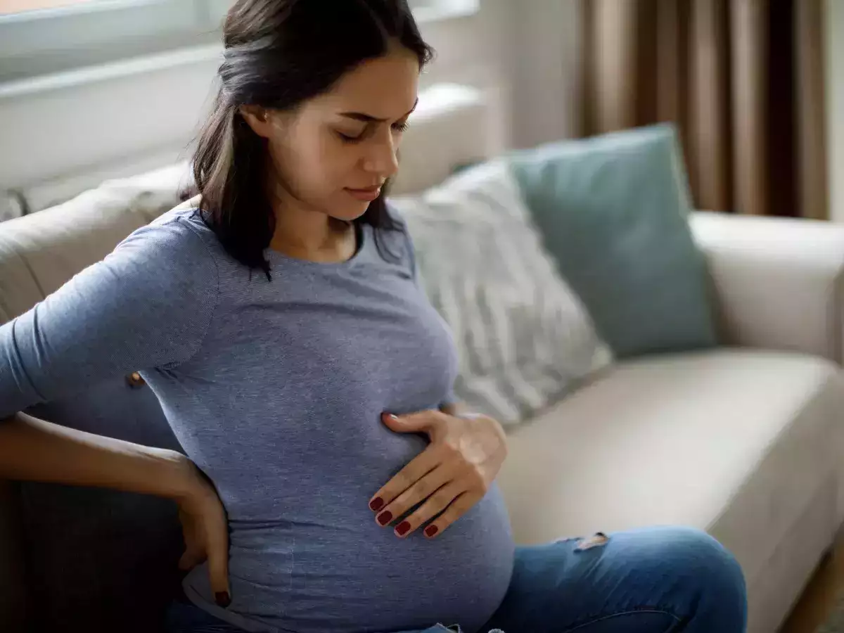 A pregnant woman sitting on the sofa
