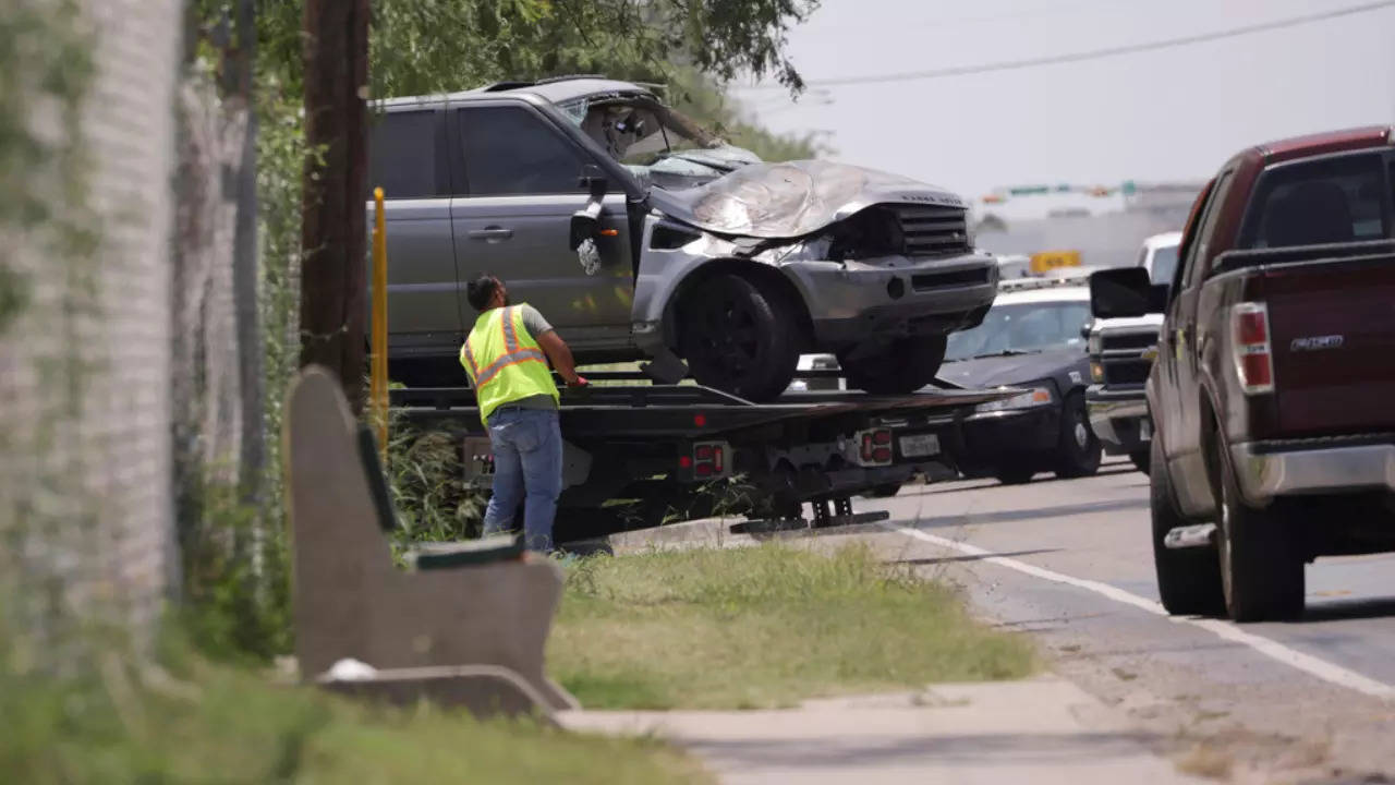 Emergency personnel take away a damaged vehicle after a fatal collision in Brownsville, Texas