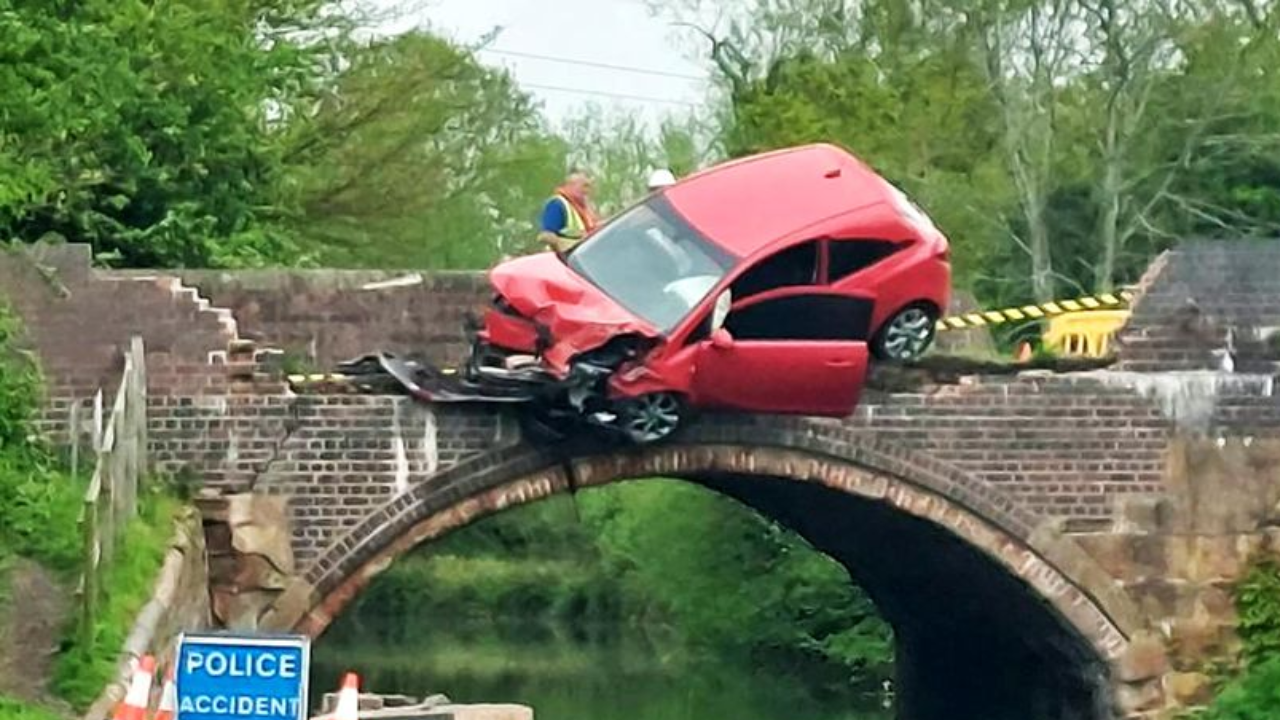 Car dangles over bridge