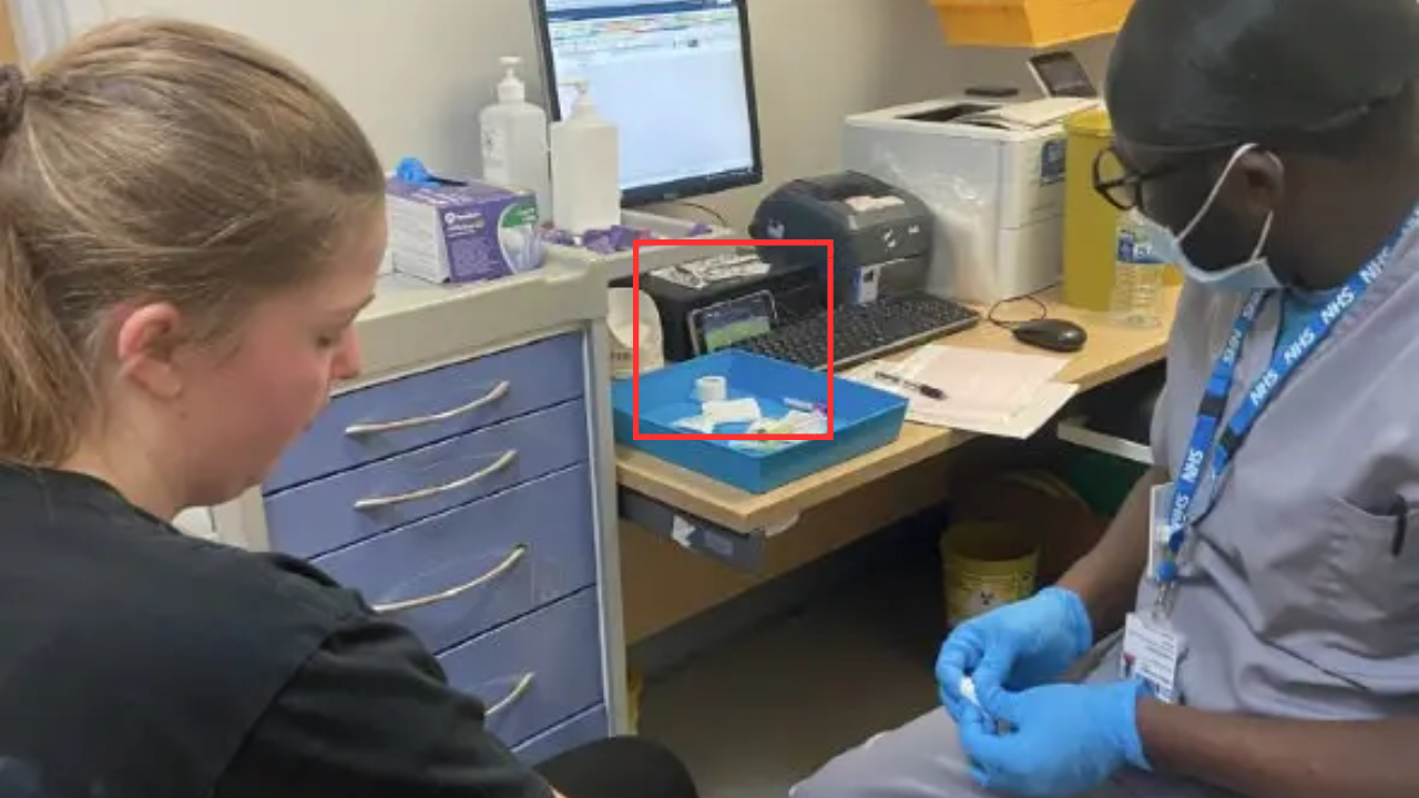 Nurse watches football while taking blood