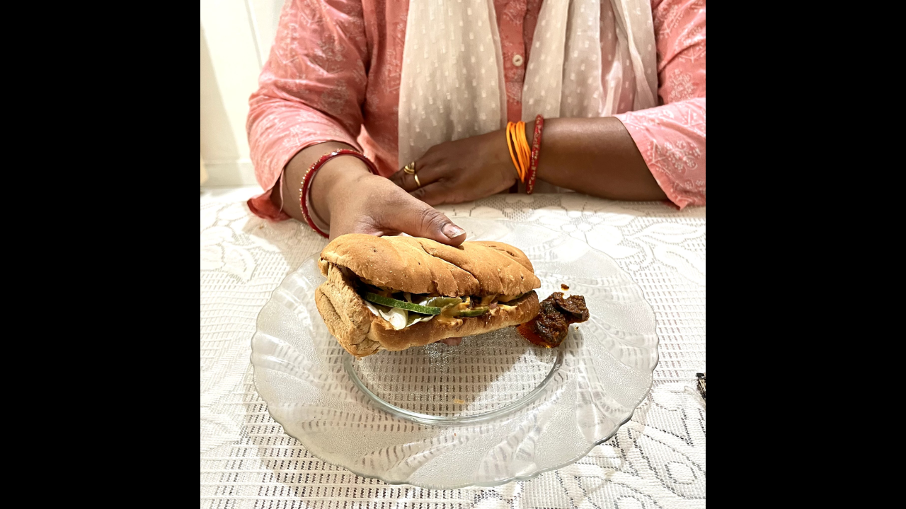 Mom eats Subway sandwich with achaar