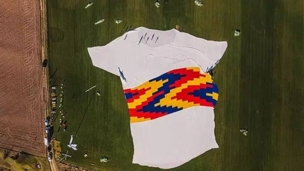 The world's largest t-shirt, made from 500,000 recycled plastic bottles, was unfurled on a Romanian Rugby pitch | Guinness World Records