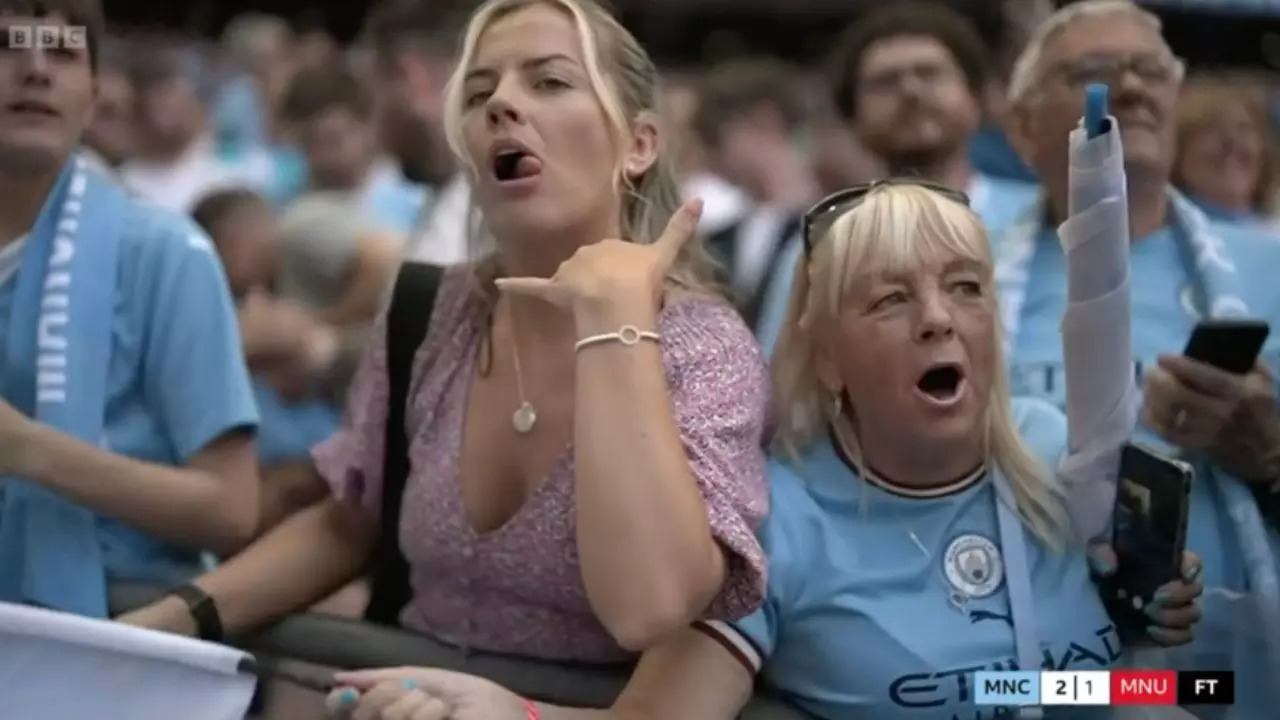 A Manchester City fan gestures 'call me' during live FA Cup Final coverage |  BBC (Screenshot)