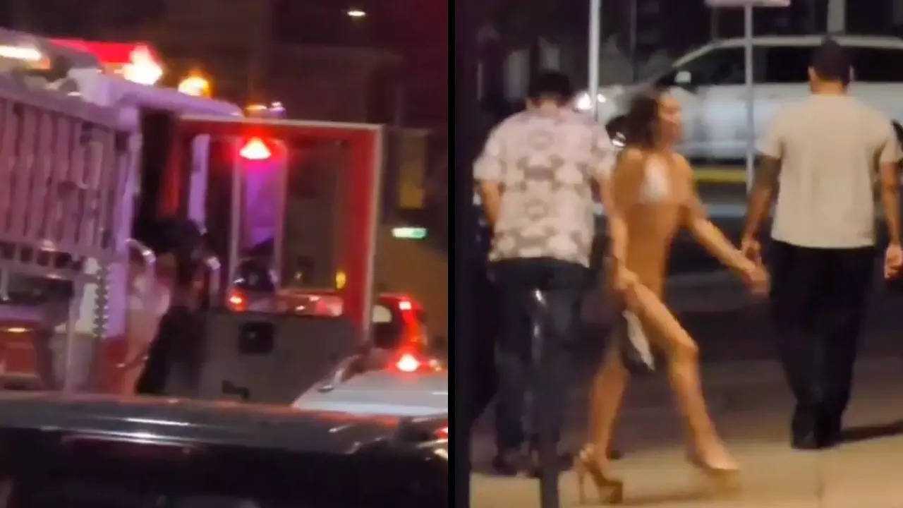 A bikini-clad woman exits a San Jose Fire Department truck outside the Pink Poodle | Screenshot from Twitter video