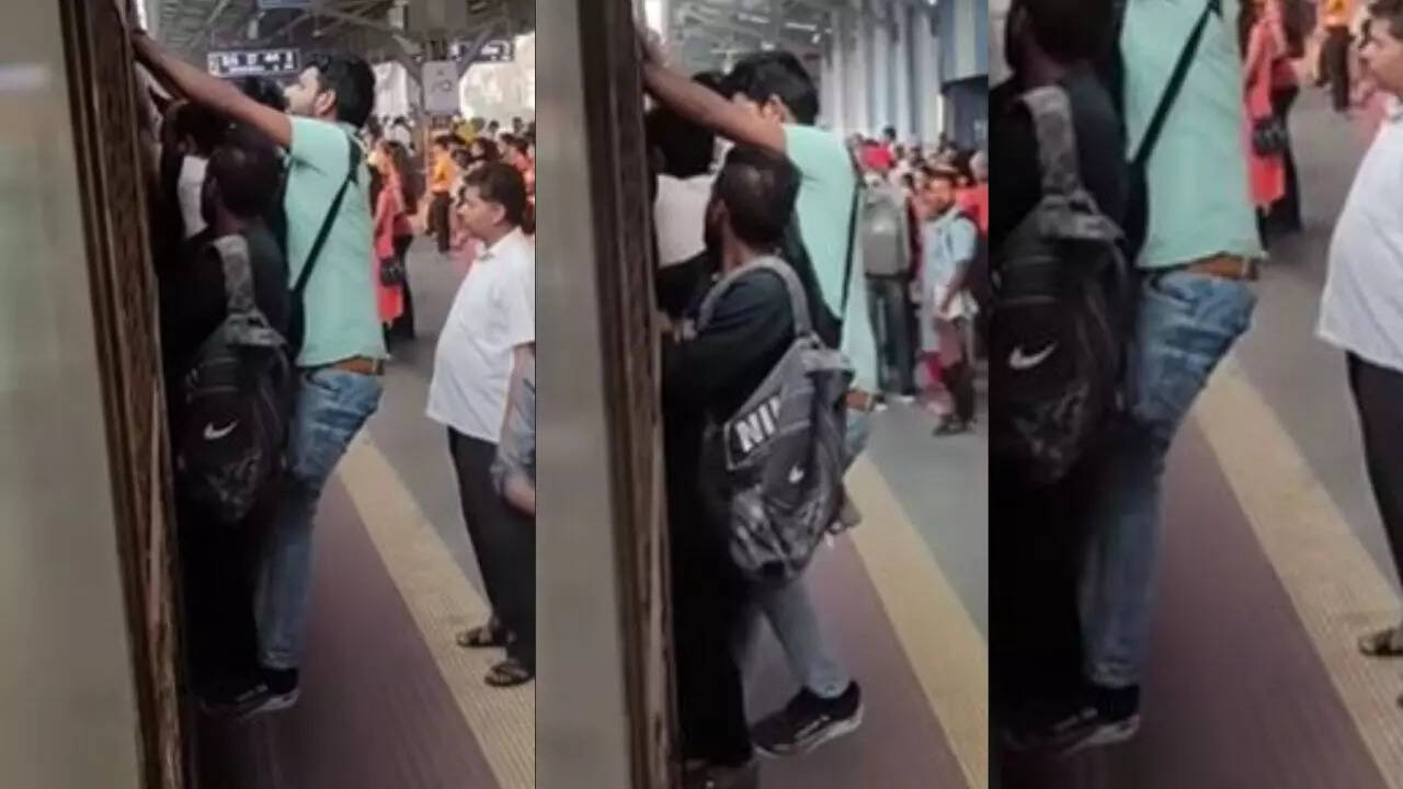 Mumbai Local Man Daringly Hangs On To The Door Of A Moving