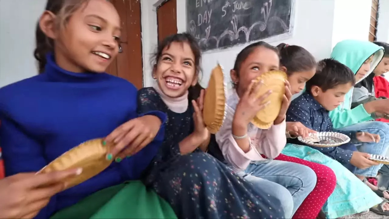 Villagers in Burans Khanda, Uttarakhand, enjoy momos at a 'party' orgainsed by a Youtuber| Screenshot: Ashwani Thapa/Youtube