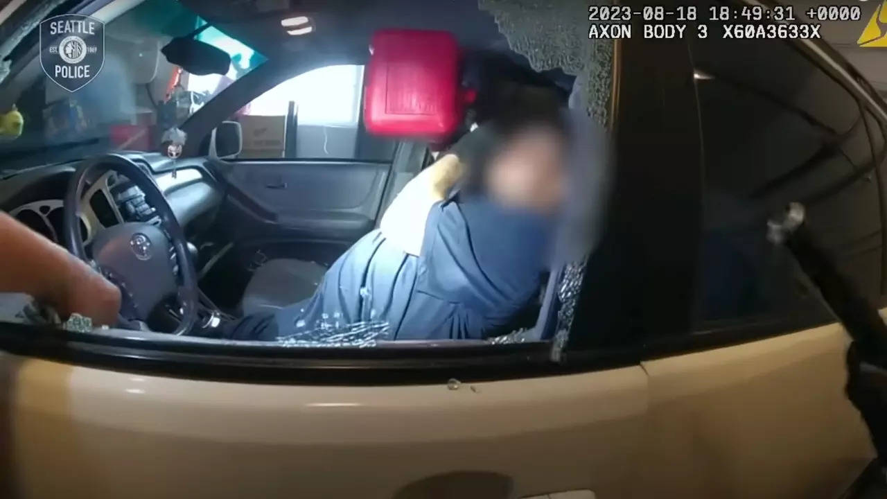 Burglary suspect Christopher Abbott drinks petrol as officers confront him for alleged home invasion. | Screenshot from Seattle Police Department bodycam footage