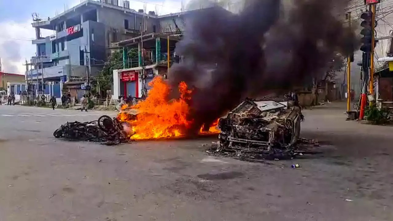 Vehicles in flames after violence broke out, in Imphal. (PTI file photo)