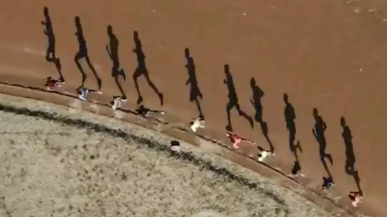 Long shadows cast by joggers on a running track create an optical illusion in Kenya.  | Courtesy: krynds