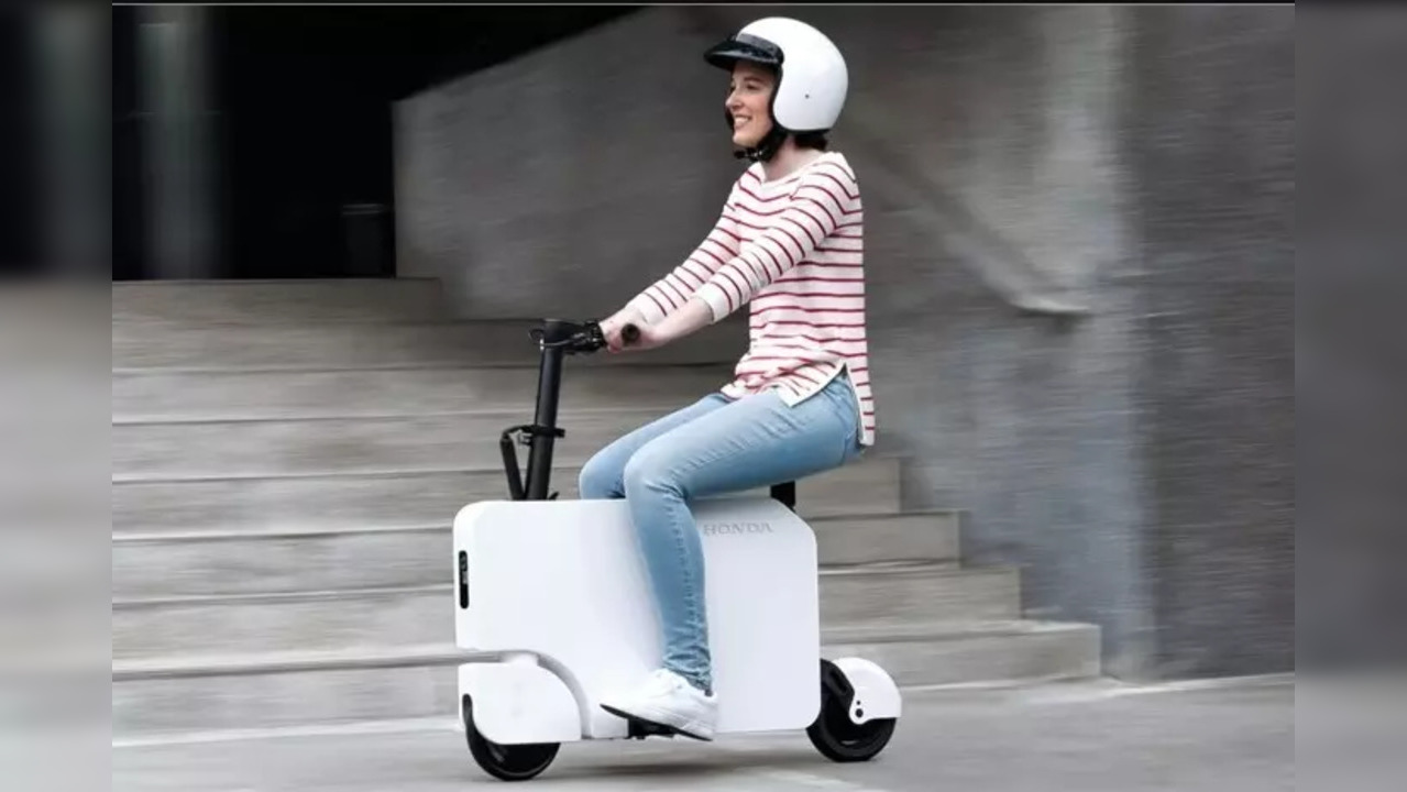 Honda has rolled out the Motocompacto, a mini electric scooter designed to transform into a compact suitcase-like form.