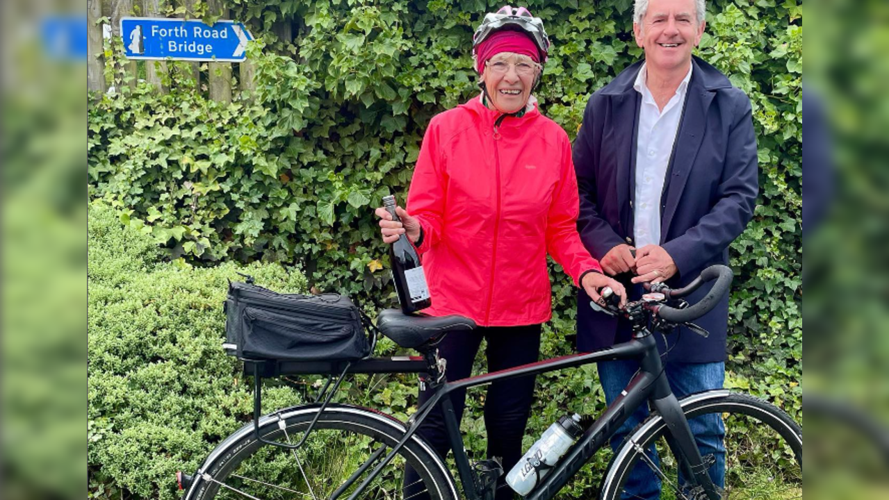 Granny Mavi 85-year-old cyclist with bottle of champaigne 