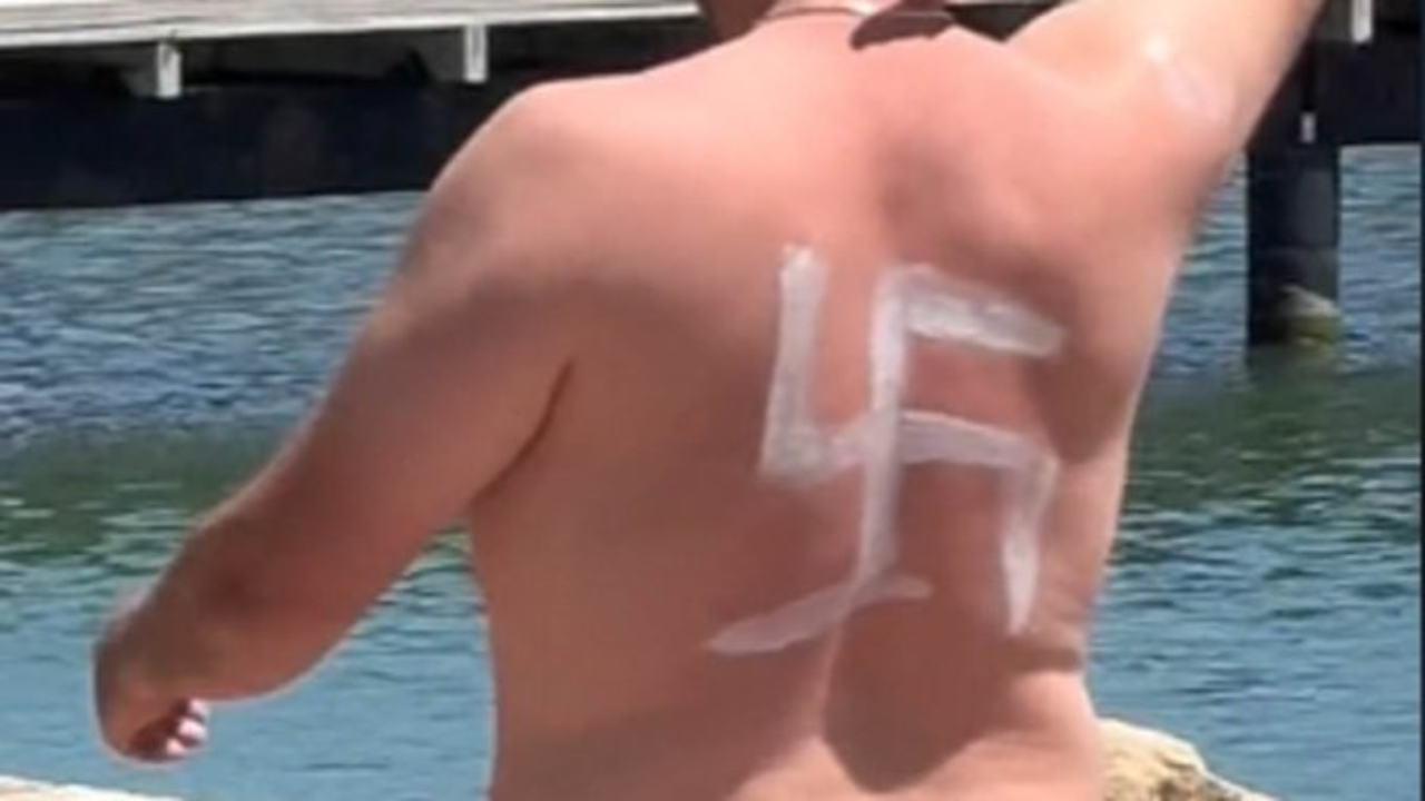 Man Walking Around With Swastika