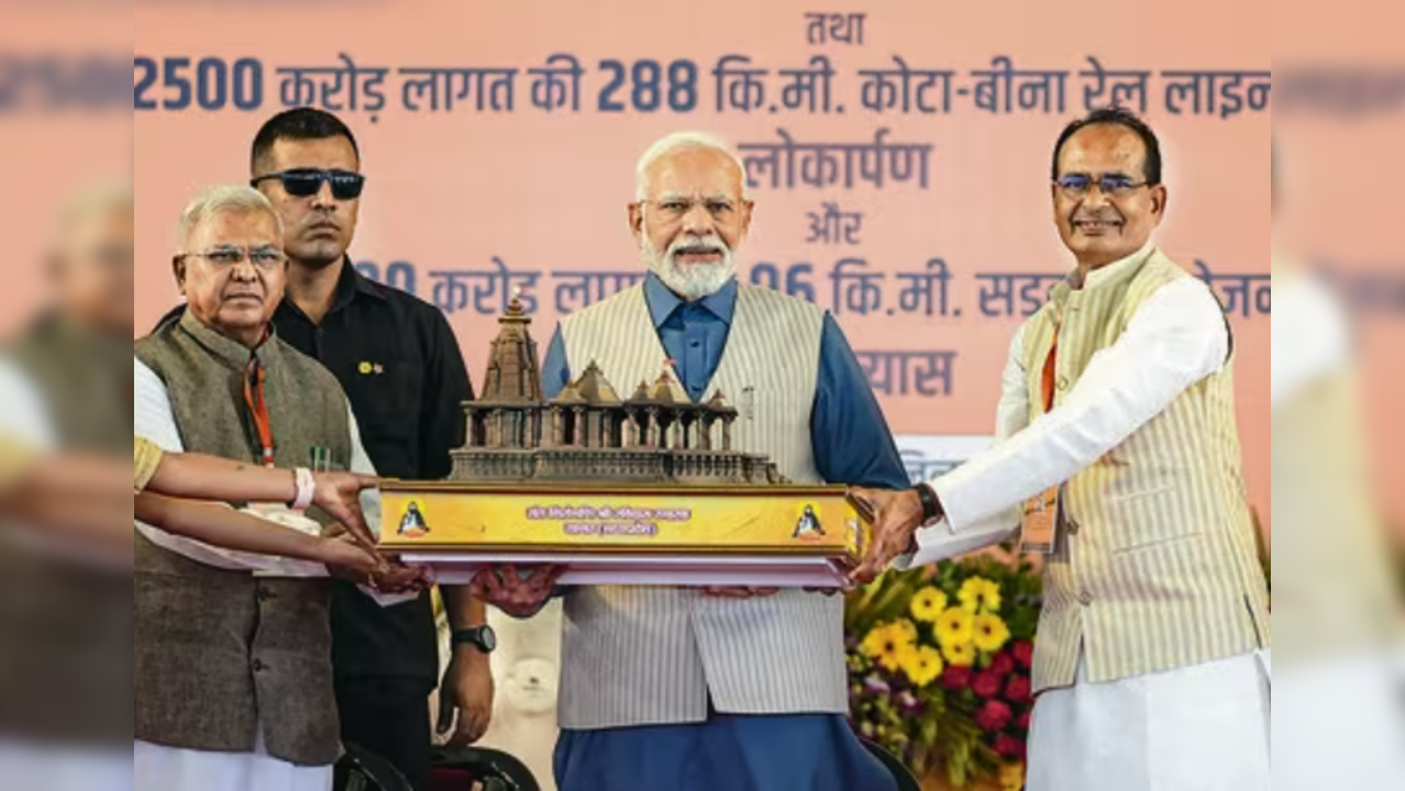 Prime Minister Narendra Modi being presented a memento during the foundation stone laying ceremony of the memorial of Sant Ravidas