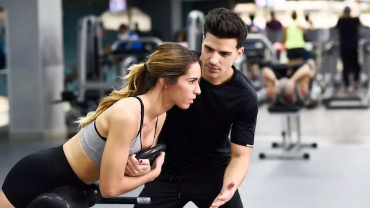 Woman overfriendly with gym trainer