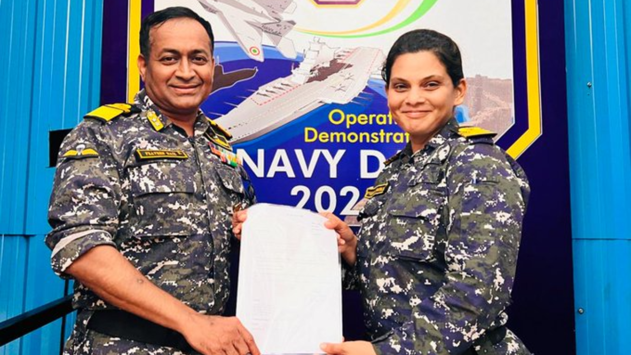 Rear Admiral Praveen Nair presenting the appointment letter to Lt Cdr Prerna Deosthalee