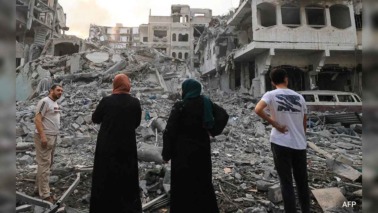 Photo of women looking at rubble amid Israel-Hamas war