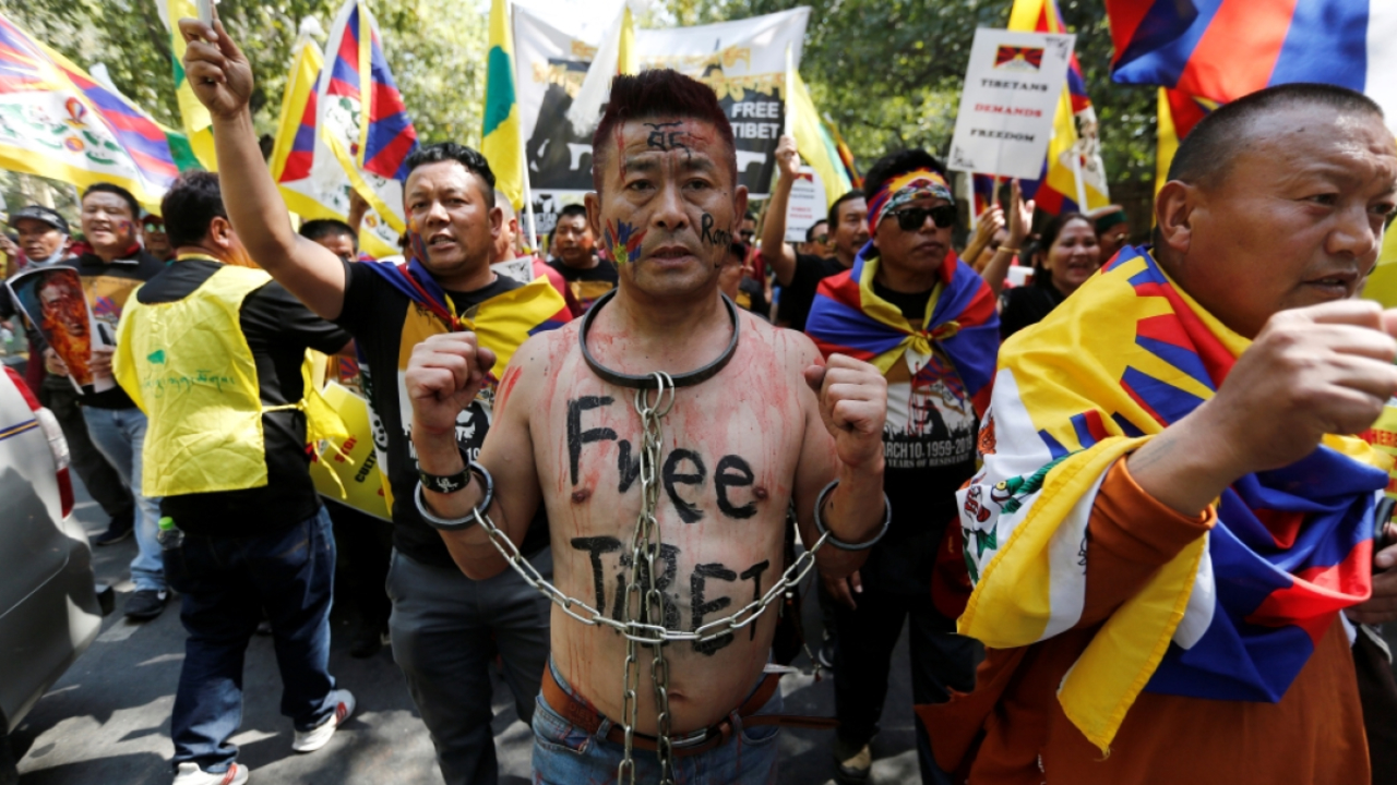 A Tibetan chains himself during a protest held to mark the 60th anniversary of the Tibetan uprising against Chinese rule (File Photo)