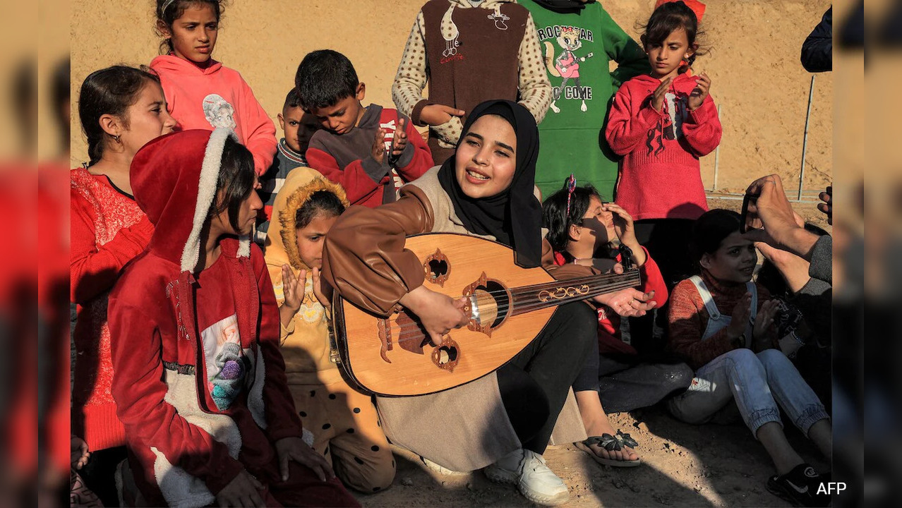 Hassuna is part of a troupe of more than a dozen volunteer entertainers who travel from camp to makeshift camp on a mission to provide children with some escape