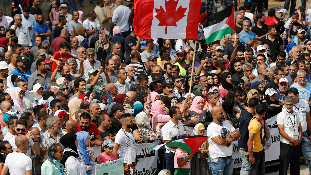 Palestinian refugees waving Canadian flags