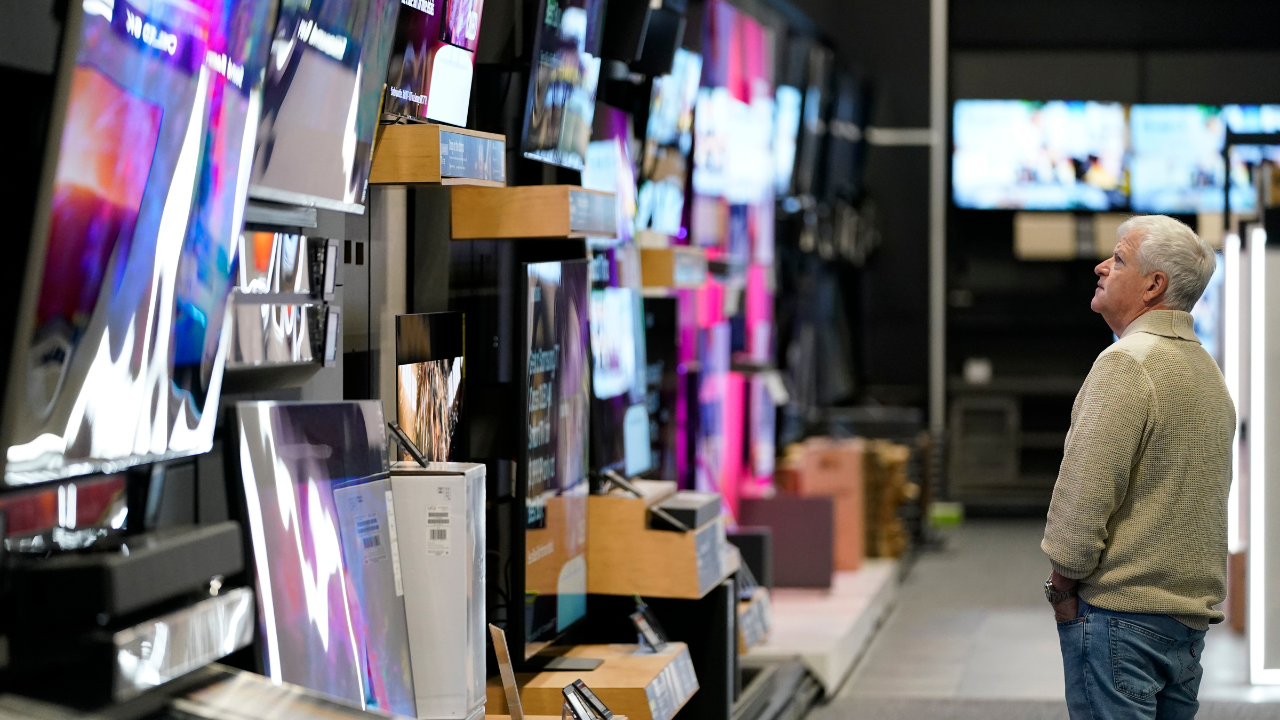 A customer browses televisions at a Best Buy store