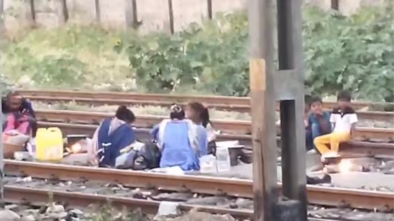 People seen sleeping, cooking food on local train tracks