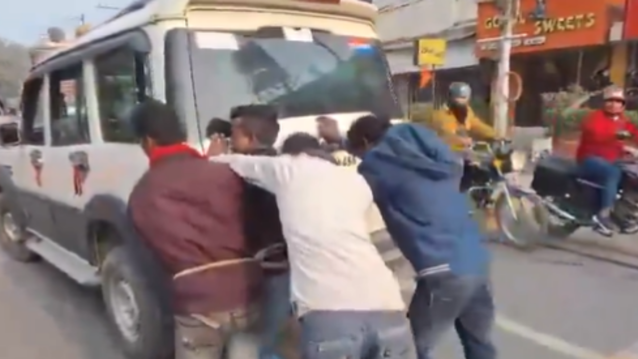 Accused Men Pushing Police Van Out of Fuel.