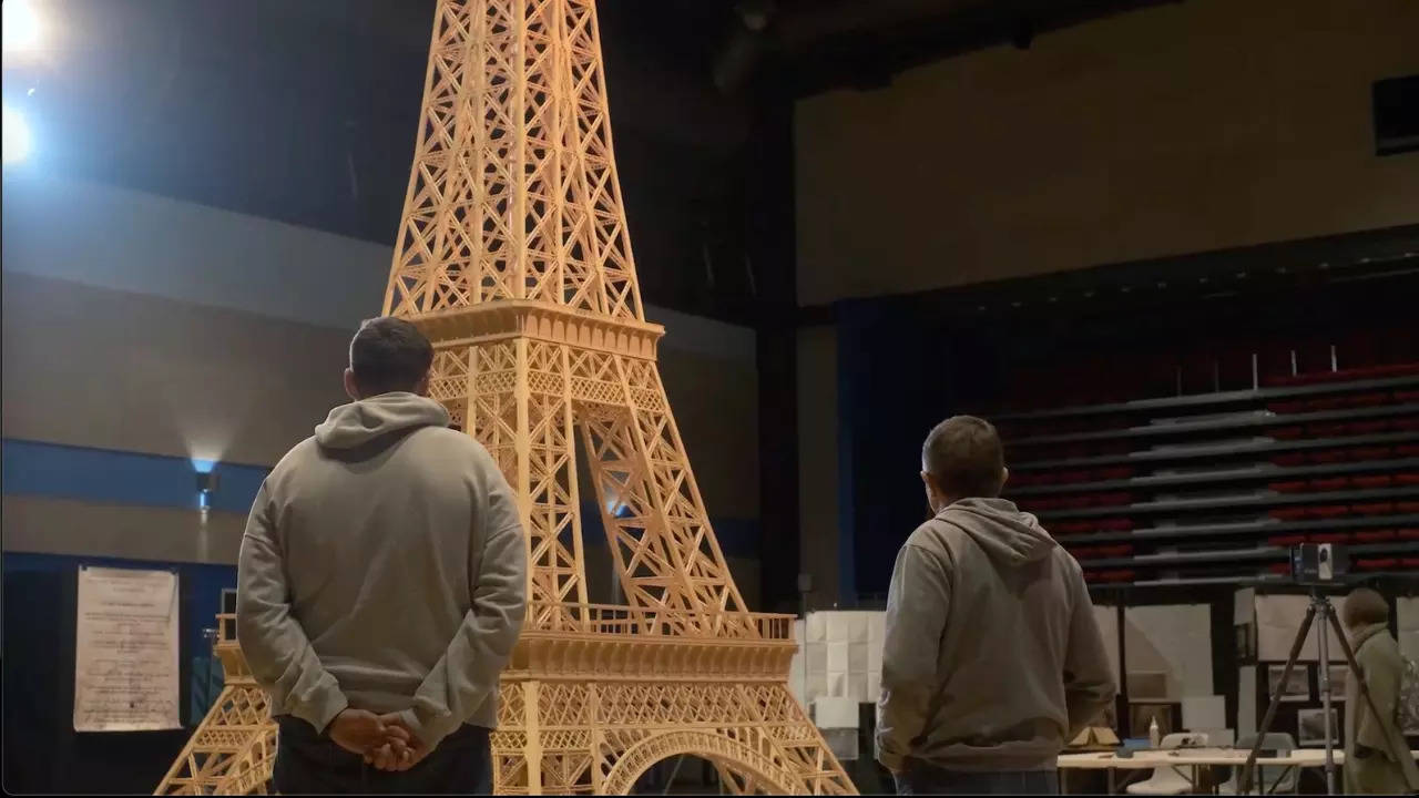 Richard Plaud looks at his Eiffel Tower replica before Guinness World Records disqualified it. | Courtesy: toureiffelallumettes/Instagram