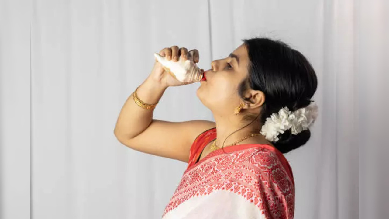 Blowing of conch shells before puja