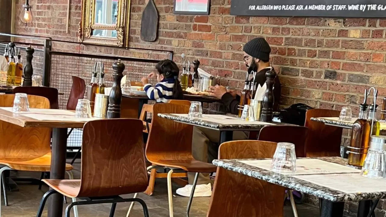 Virat Kohli pictured with his daughter, Vamika, at a restaurant in London. | Courtesy: Reddit/X