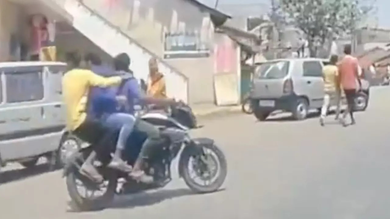 Triple-riding bikers moments before colliding with a car near Bengaluru. | Courtesy: @DriveSmart_IN/X