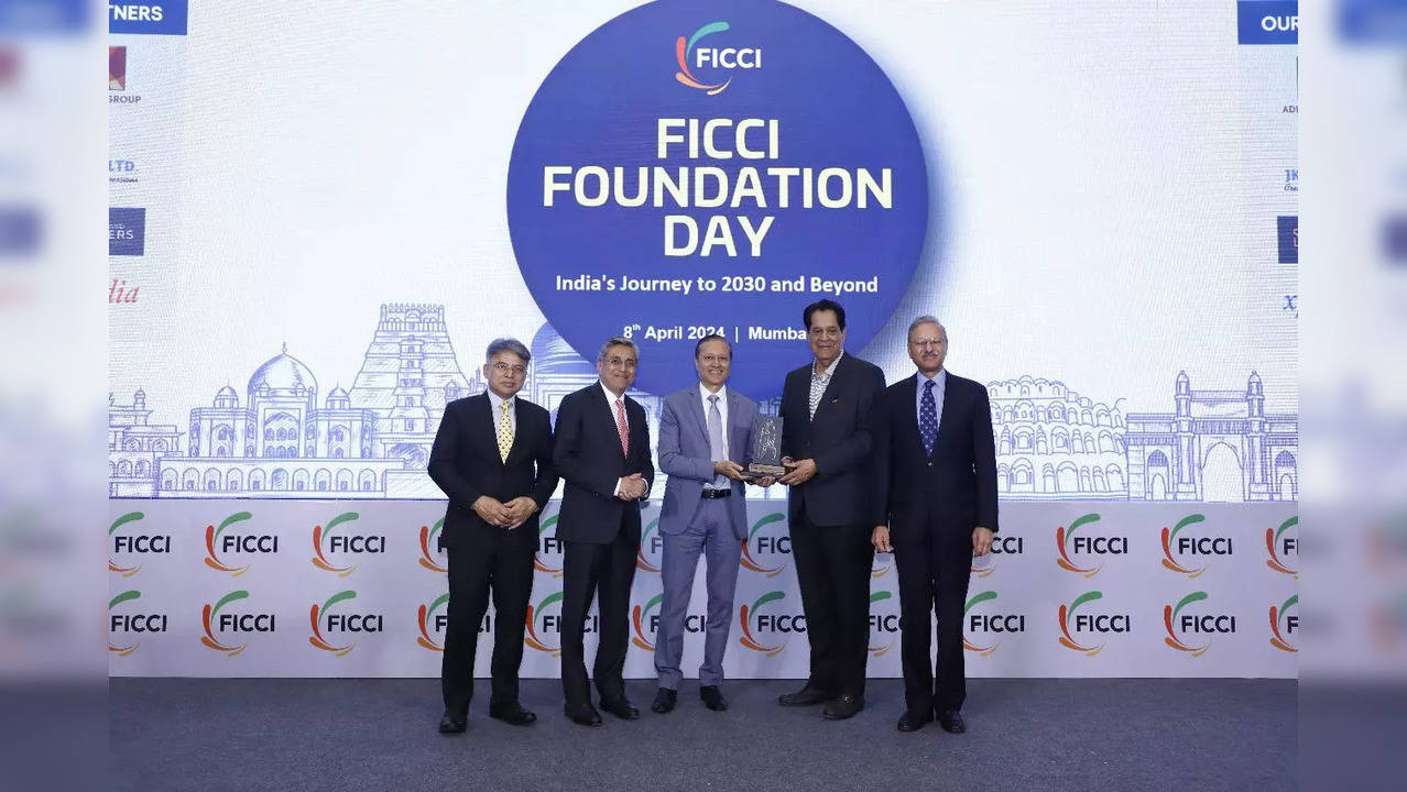 ​Times Group MD Vineet Jain received a memento after his grandfather SP Jain was honoured during FICCI​ Foundation Day celebration.​